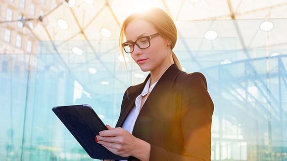 woman in suit using ipad woman in suit using ipad