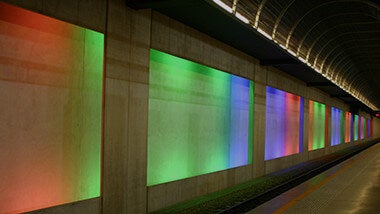 Colourful red, green and blue screen projections on wall