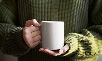person holding a mug