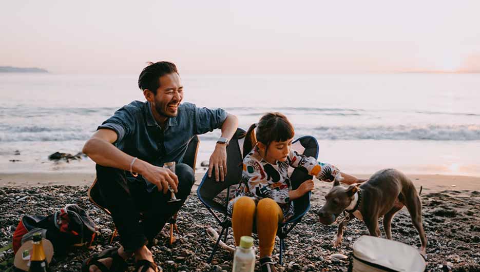 MY-1b-cropped man on beach with family-935x530px (1).jpg